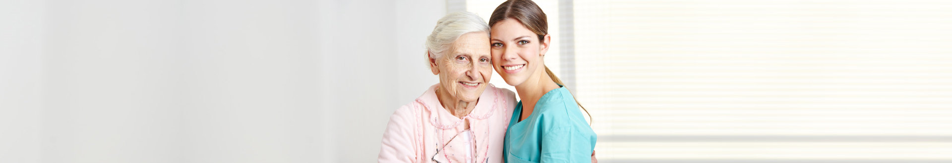 senior woman hugging her caregiver